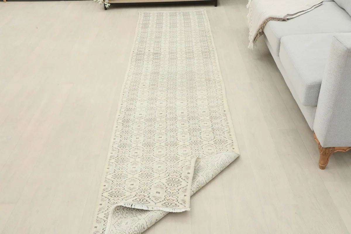 Runner rug partially unrolled in a room, showing its flexibility and the full pattern