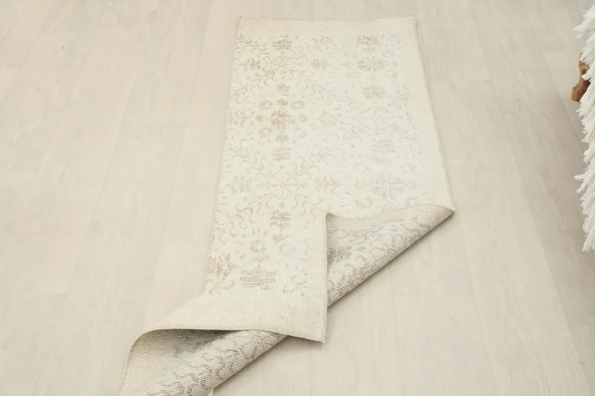 View of the runner partially folded, revealing the wool pile on cotton foundation and flexibility.