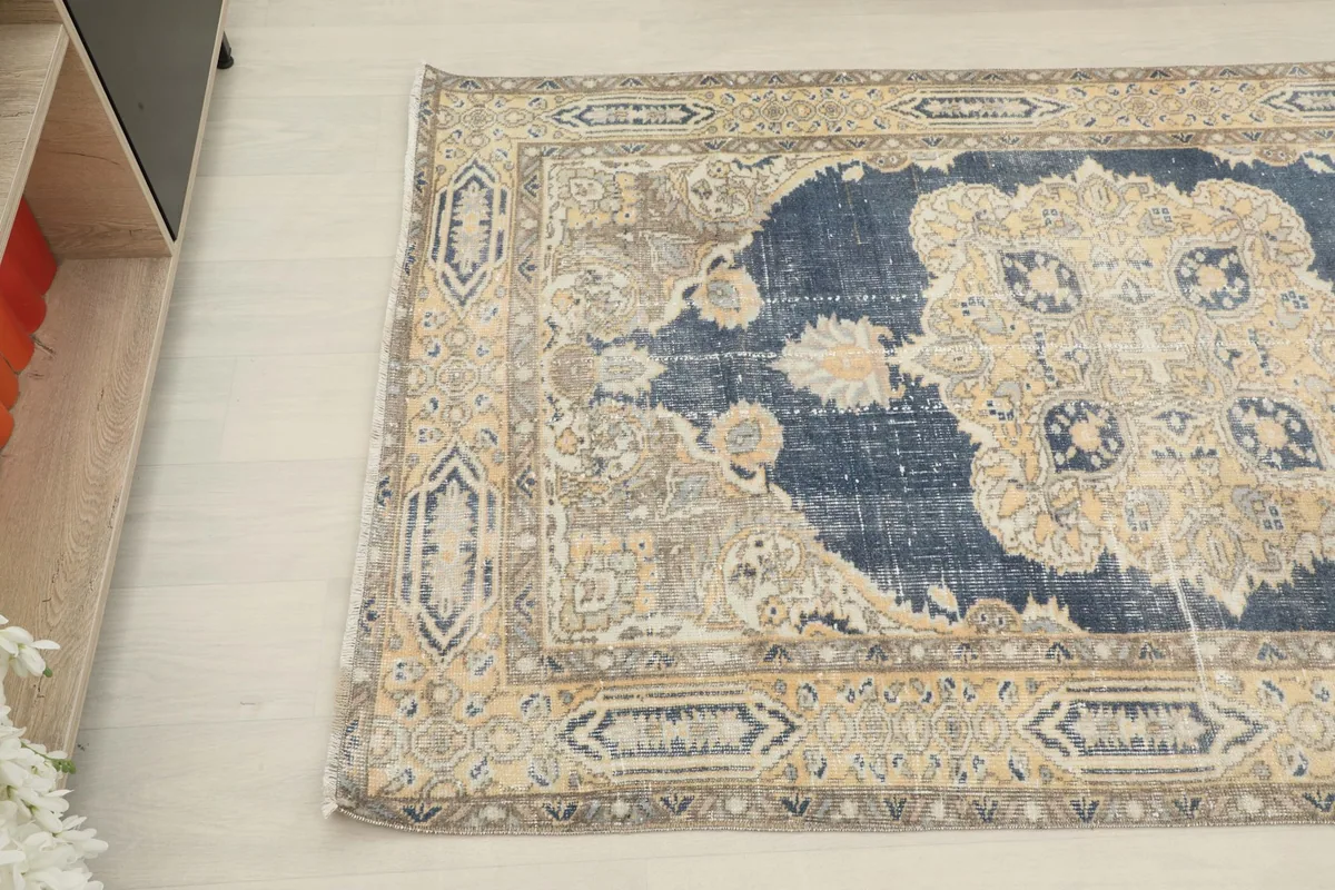 Overhead angle view of the rug's left side, showcasing the border and field transition