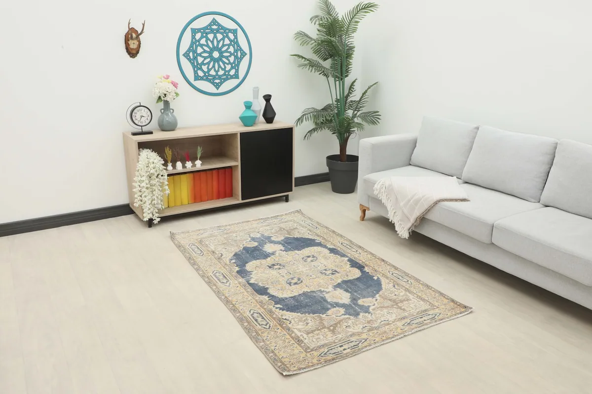Vintage Anatolian rug displayed in a bright living room setting with a light gray sofa