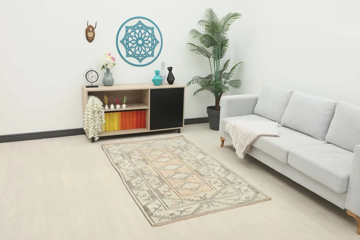Vintage Anatolian rug displayed in a living room setting with a light sofa and console