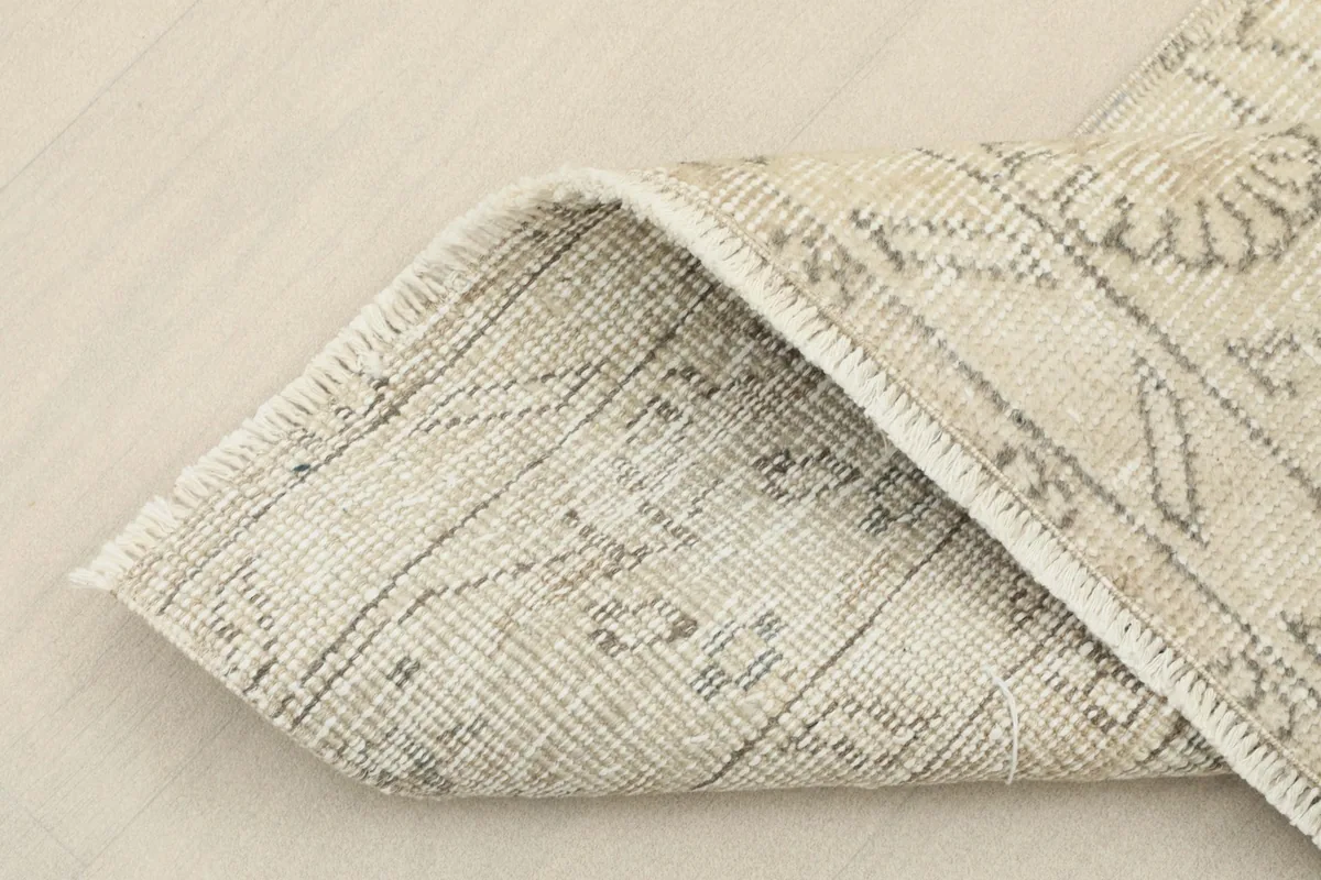 Close-up of the rug's back, showing the tight hand-knotting and cotton foundation