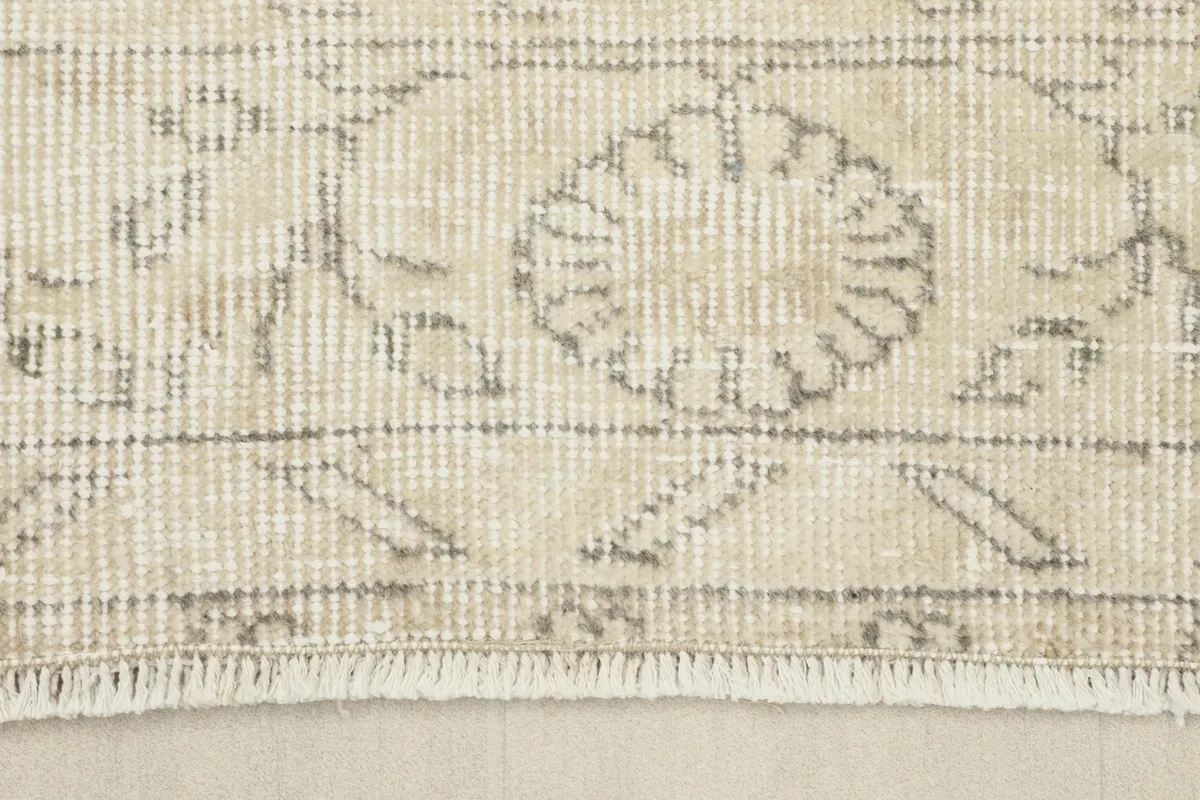 Close-up of the rug's fringe and a section of the border pattern, showing its soft finish