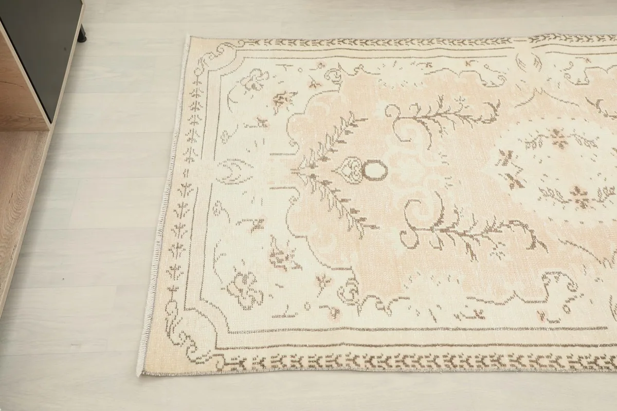 Angled shot of the rug's top half, revealing the soft color transitions and motifs