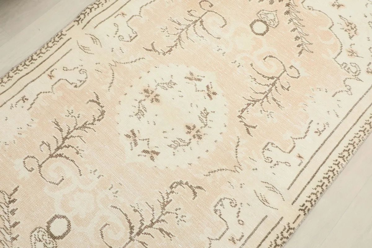 Detailed view of the rug's central medallion and surrounding floral and geometric elements