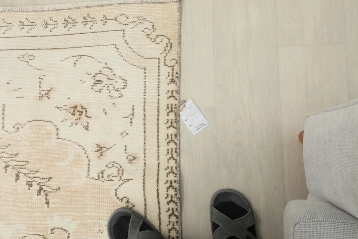 Overhead view of a section of the rug, showing its border and the floor beyond