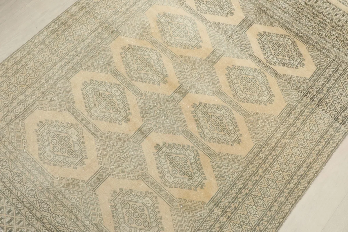 Overhead view highlighting the central geometric design and texture of the rug.