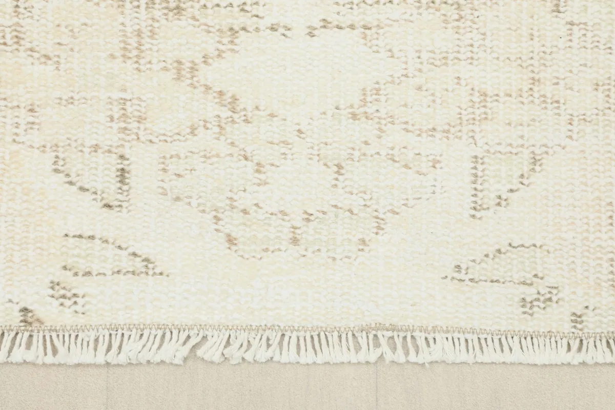 Close-up of the rug's fringe and a portion of the main field, showing the intricate knotting detail.
