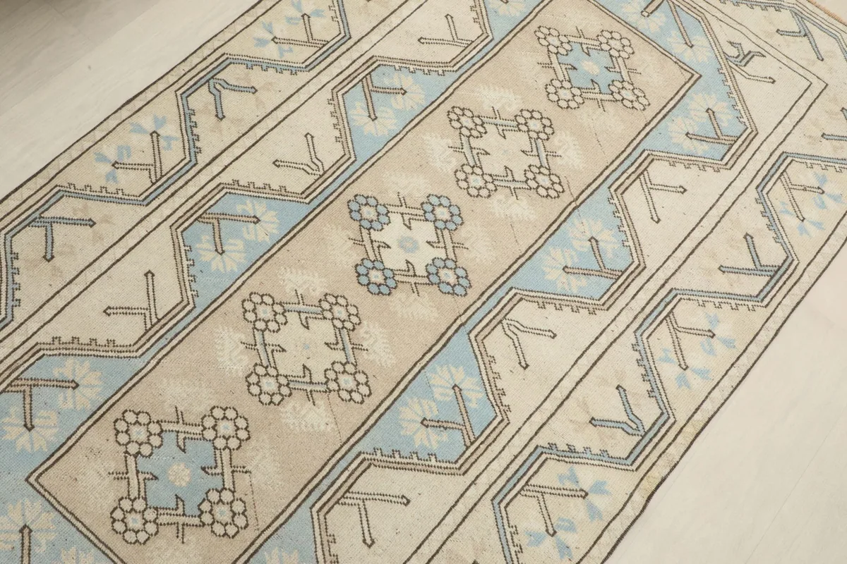 Diagonal overhead view of the rug's central design, showcasing the repeated tribal motifs