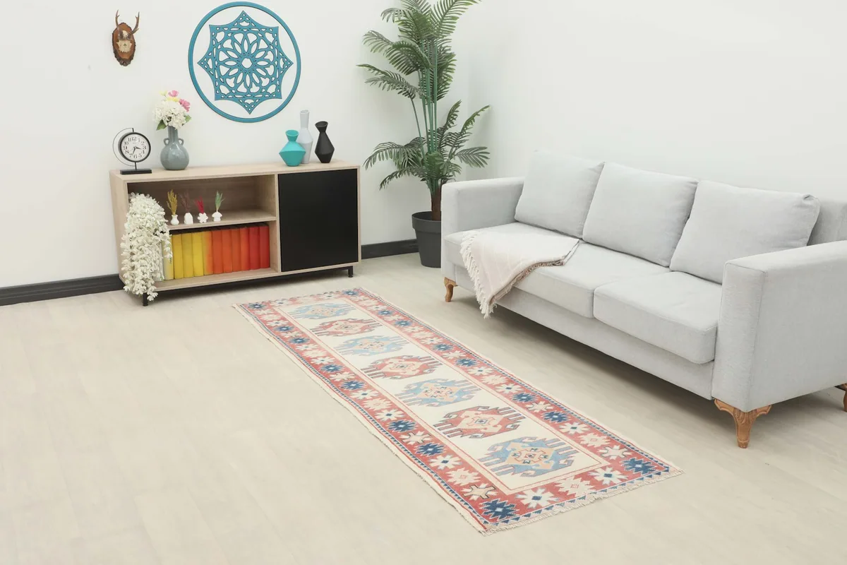 Vintage Anatolian runner rug displayed in a modern living space with a light sofa and console