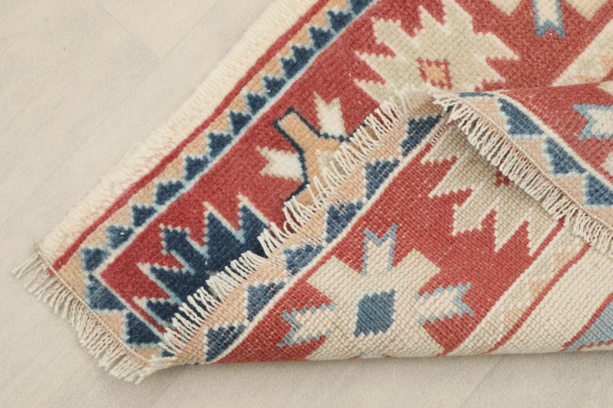 View of the back of the hand-knotted wool pile and cotton foundation near the fringe