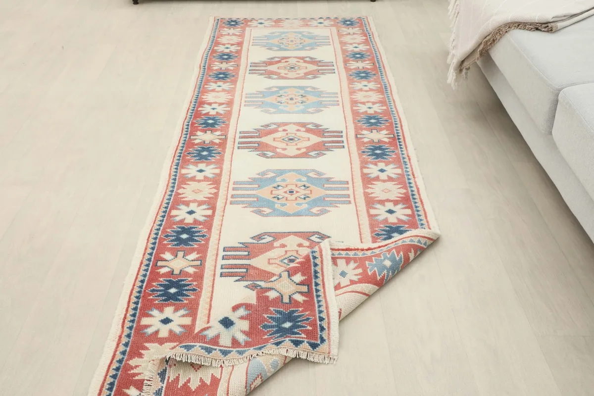 The runner rug partially folded, showing its flexibility and the full length in a room