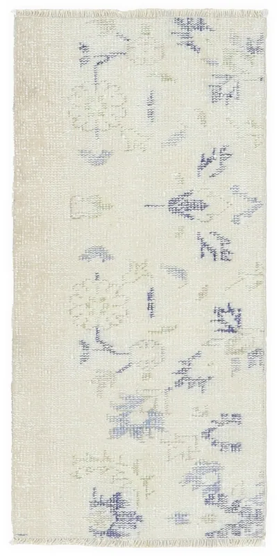 Full top view of the 1'9" x 3'8" ivory vintage Anatolian rug with blue and green botanical patterns.