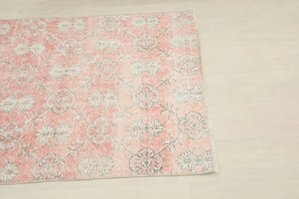 Close-up of the rose field and gray floral pattern from a corner of the rug