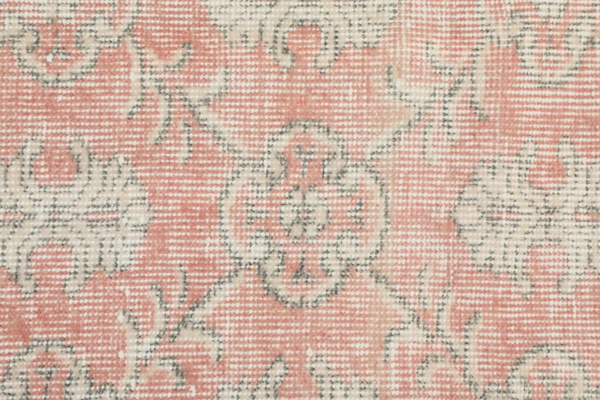 Macro detail of the hand-knotted wool pile and intricate floral motifs