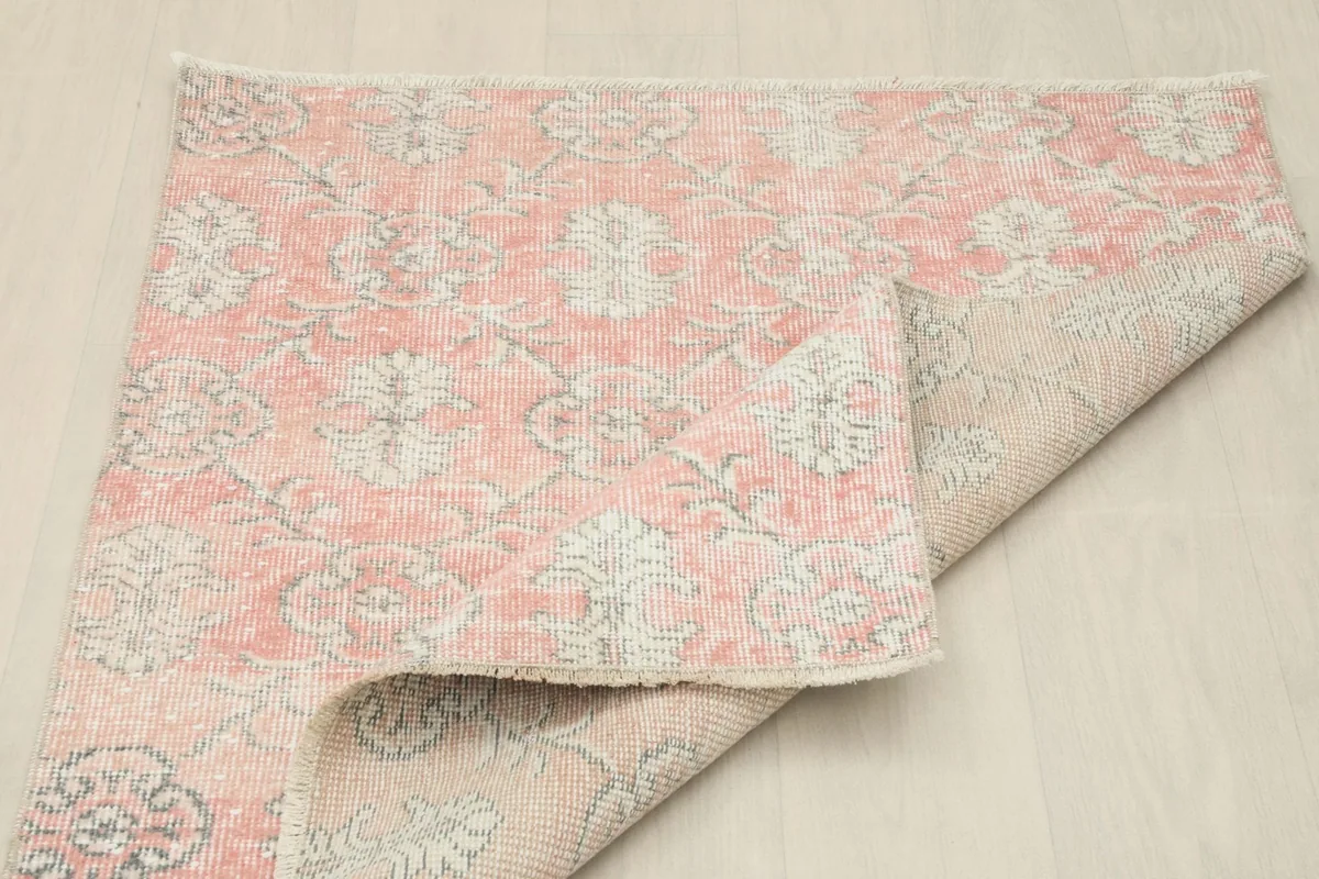 Rug corner folded, showing the back of the hand-knotted construction
