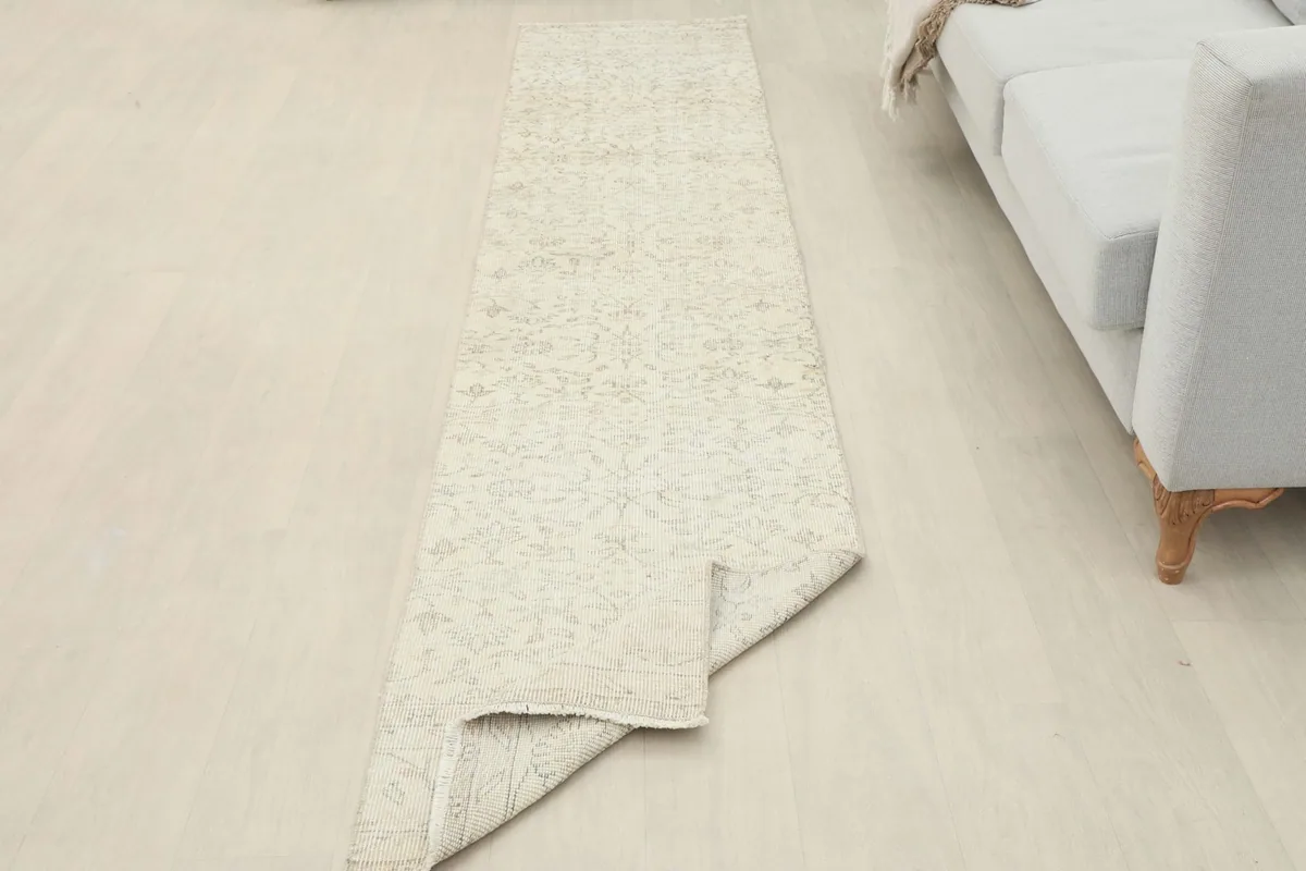 Runner partially folded, showing its placement in a room next to a light-colored sofa.