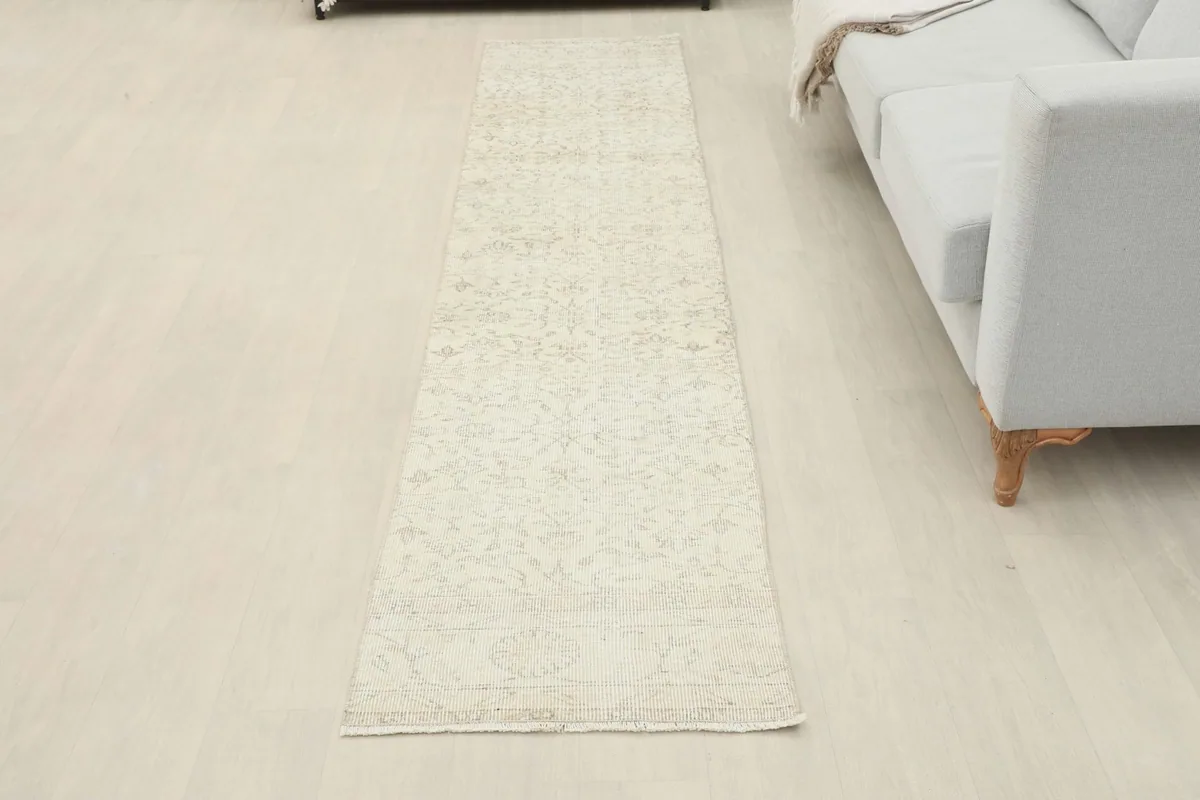 Full view of the ivory runner laid out in a room, providing a sense of its scale and design.