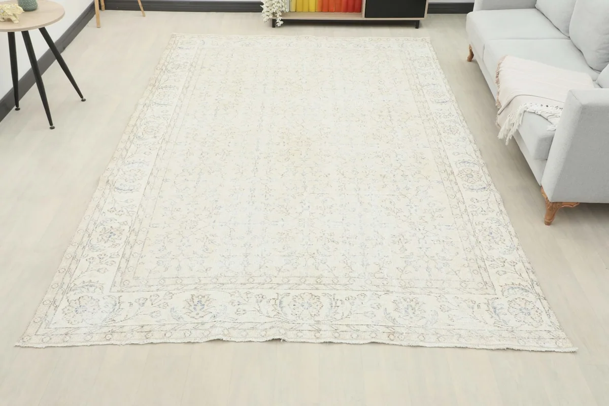 Full room view of the large ivory rug, showcasing its scale and presence