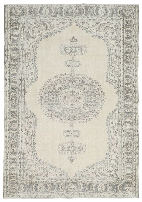 Full overhead view of the ivory and gray vintage Anatolian rug with a central medallion.