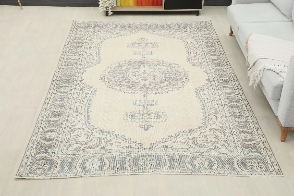 Full room view of the ivory and gray vintage rug, showcasing its scale and how it fits the space.