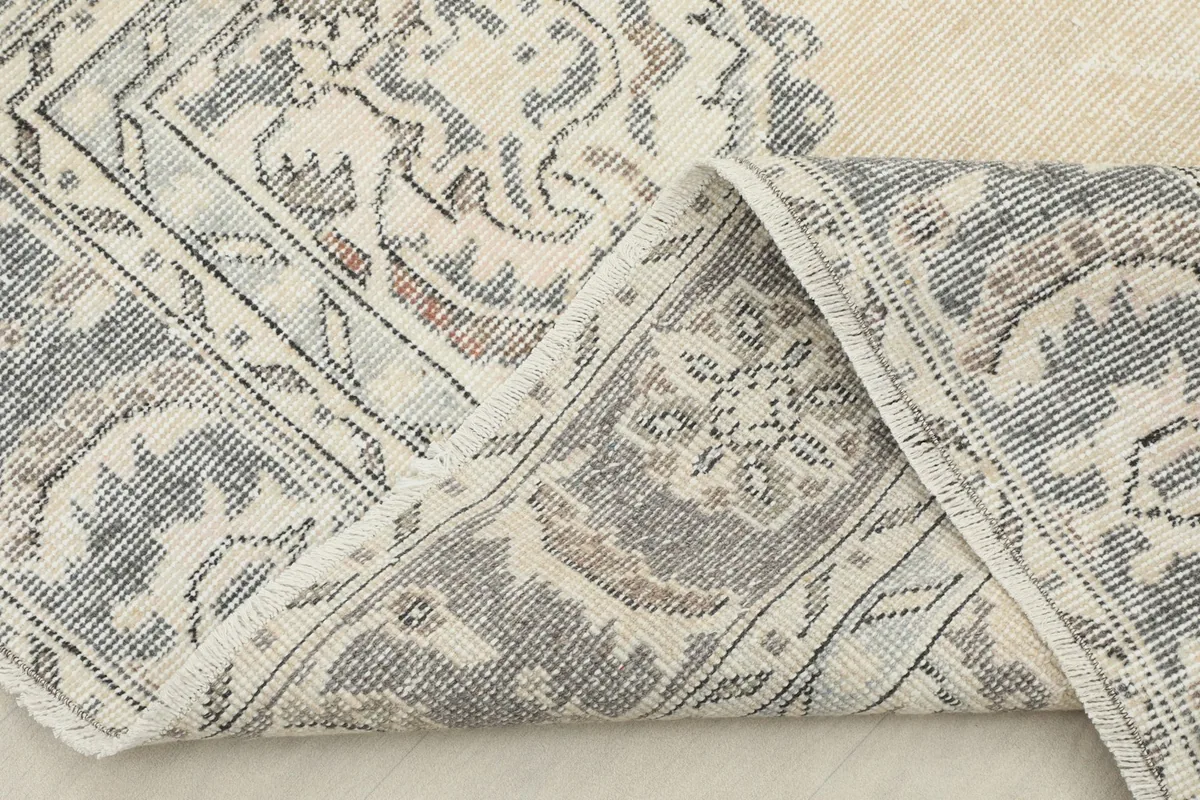 The rug folded to reveal the backside (foundation) and the density of the hand-knotted construction.