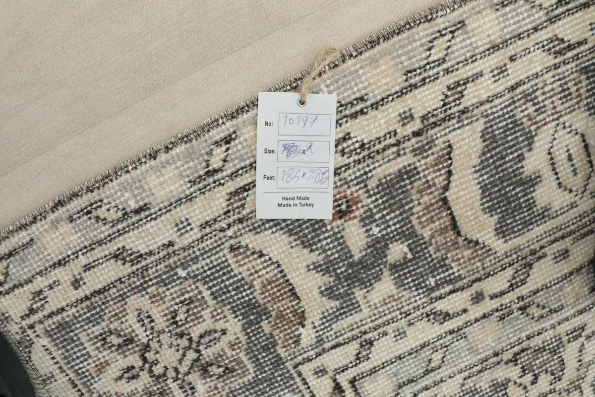 Close-up of a tag attached to the rug, indicating it is hand-made in Turkey.