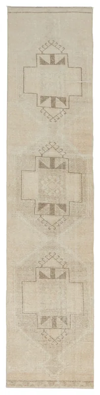 Full top view of the 2'8" x 12'4" tan and beige Anatolian runner rug with geometric tribal patterns.