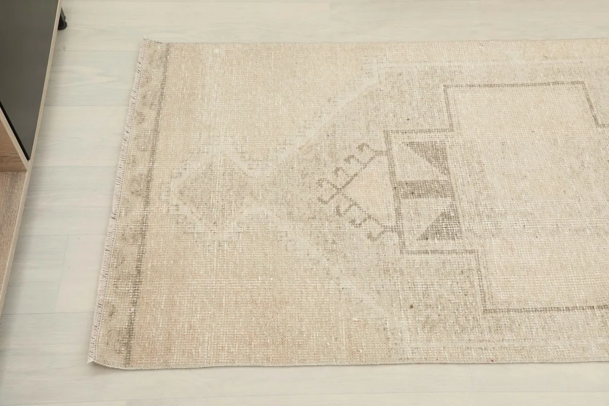 Angled view of the other end of the runner, highlighting the distressed texture and tribal design.
