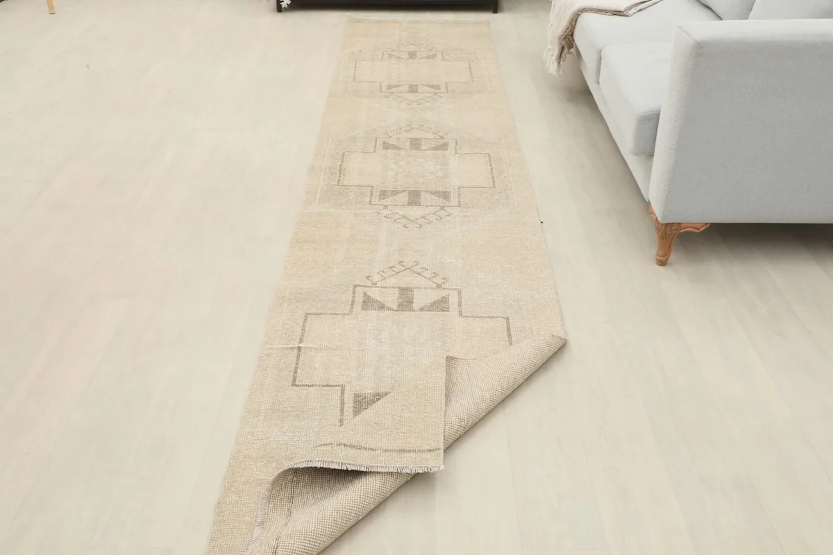 Runner partially folded, showing the flexibility and texture of the vintage wool pile.