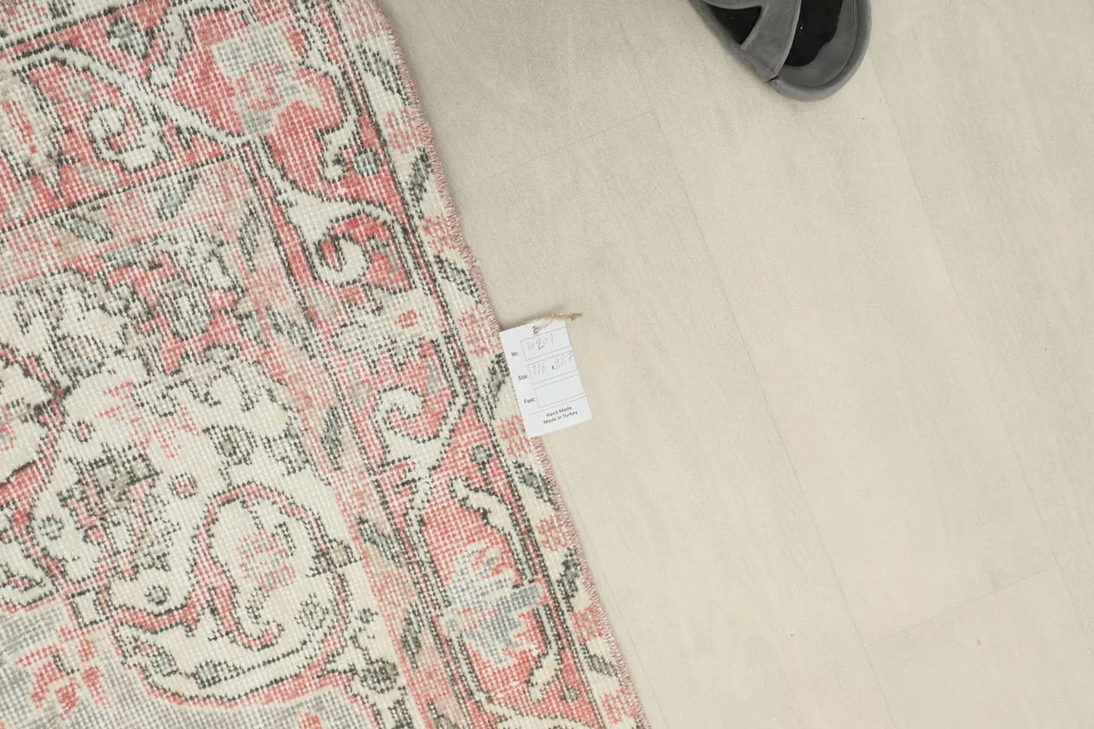 Overhead view showcasing the rug's tag and a portion of its border and field.