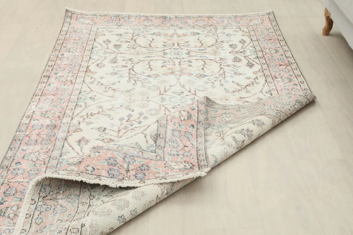 View of the back of the rug, revealing the hand-knotted cotton foundation and wool pile construction.