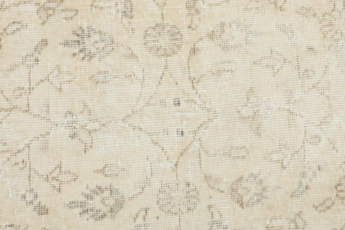 Close-up detail of the hand-knotted wool pile and intricate floral motifs