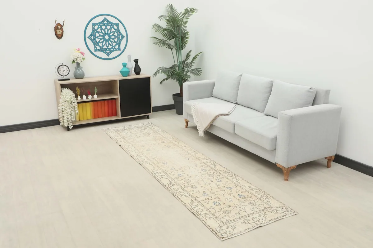 Vintage Anatolian runner placed in a modern living space with a light sofa and minimalist decor.