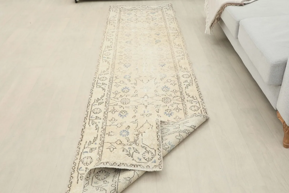 Runner partially unrolled in a room setting, showing its length and how it lays on the floor.