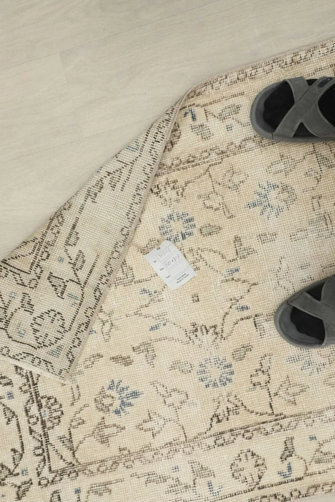 Overhead view of the runner with a pair of slippers, demonstrating scale and the low pile texture.