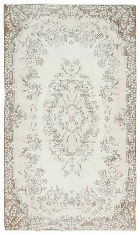Full top view of the ivory and tan floral medallion vintage Anatolian rug