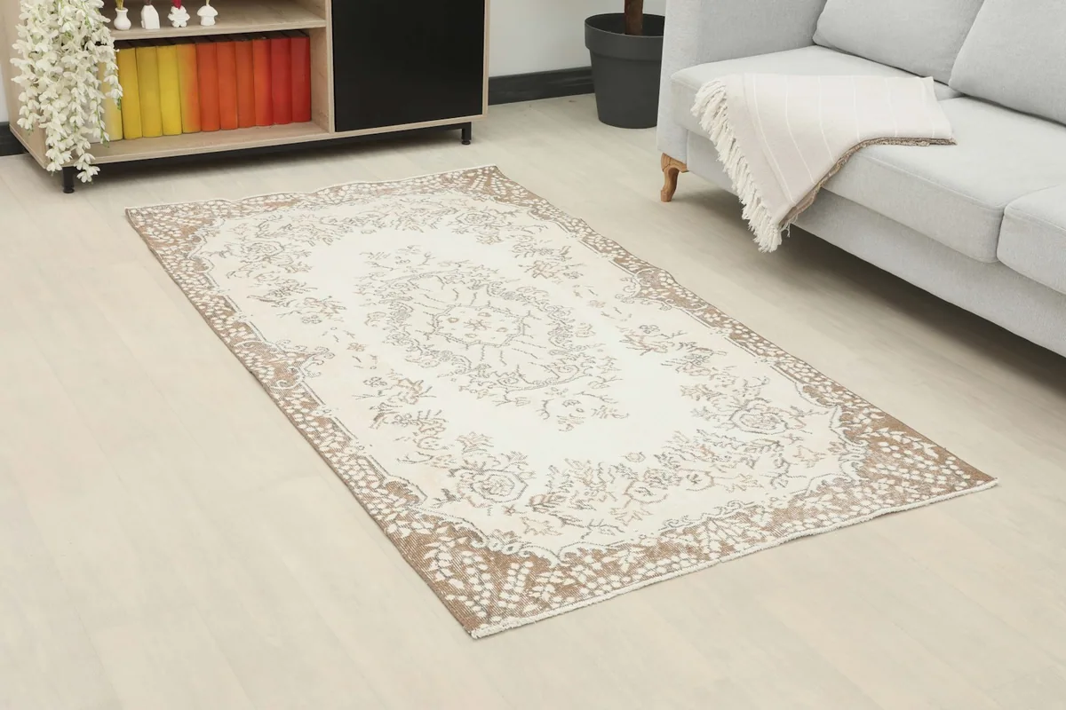 Angle view of the rug in a room, showing its placement relative to a sofa and cabinet