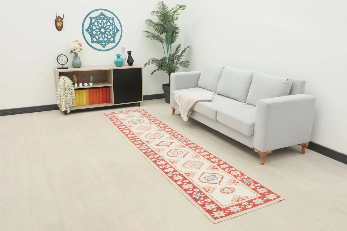 Vintage Anatolian runner rug in a modern living room setting, extending along a sofa