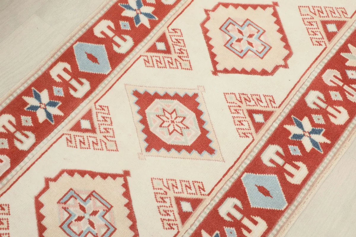 Close-up of the rug's surface, showing intricate tribal geometric patterns and colors