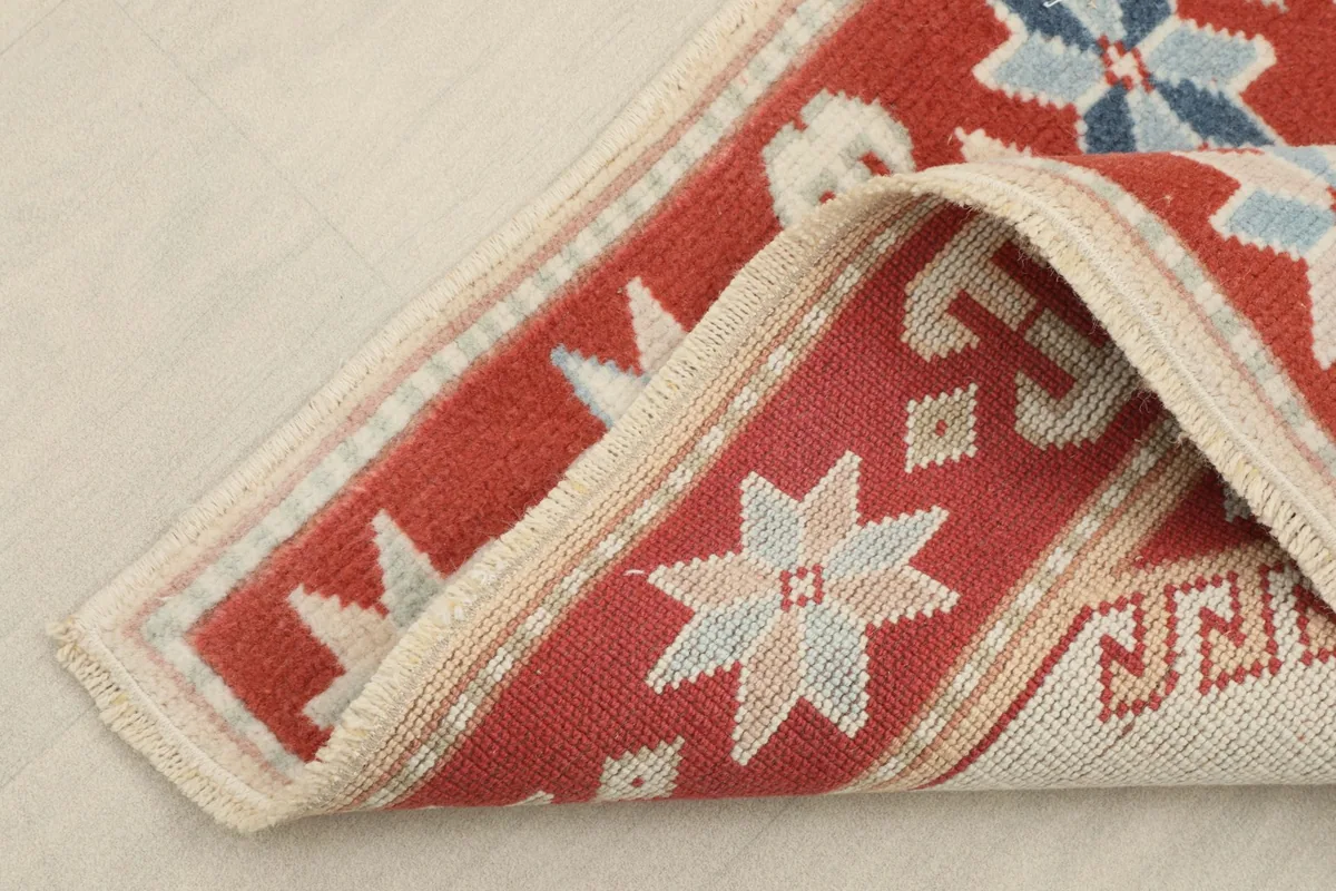 Corner of the runner rug folded to show the thickness and construction