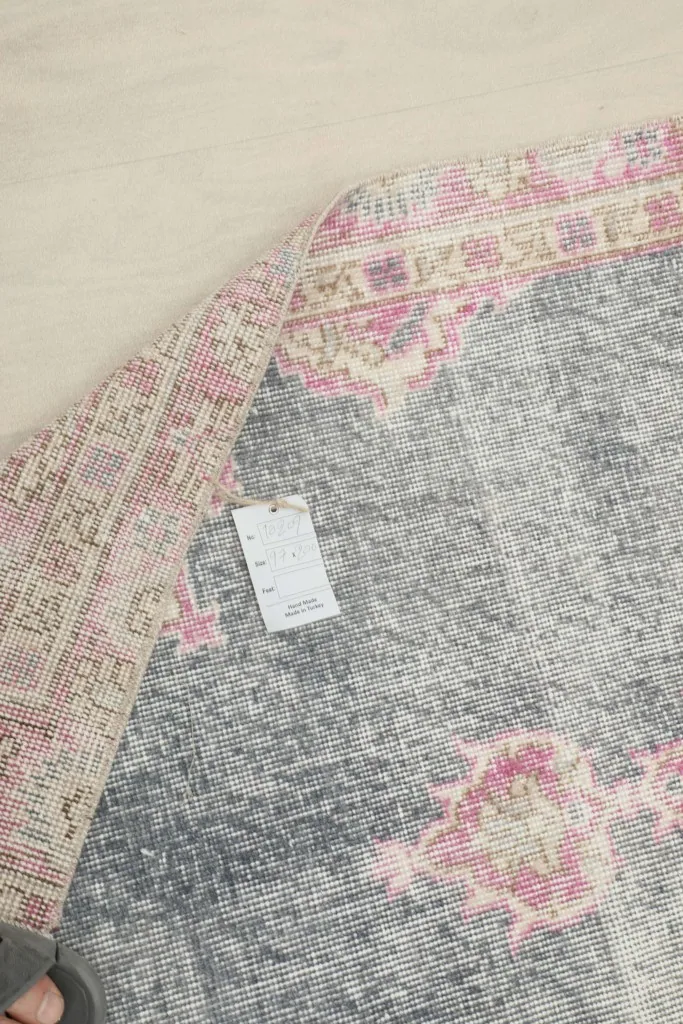 Underside of the rug with a tag, revealing the hand-knotted cotton foundation