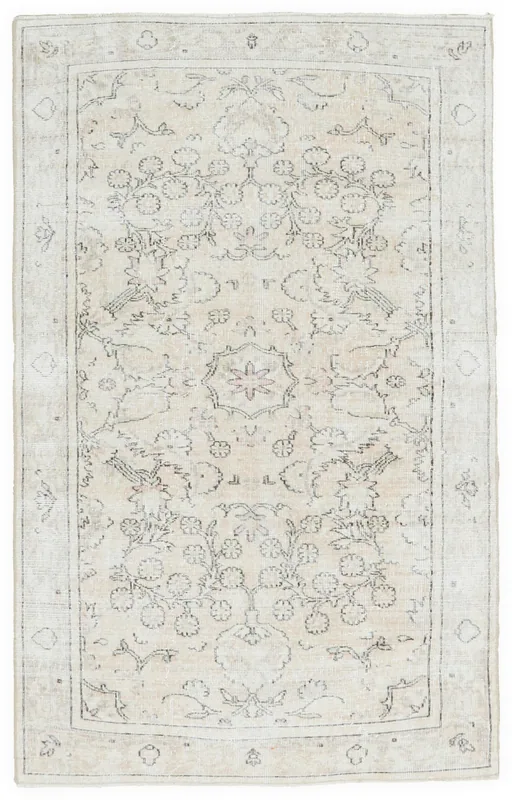 Full top view of a beige and cream vintage Anatolian rug with floral and medallion patterns
