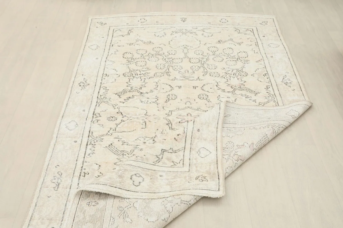 The rug partially folded back, displaying the reverse side and the texture of the wool pile
