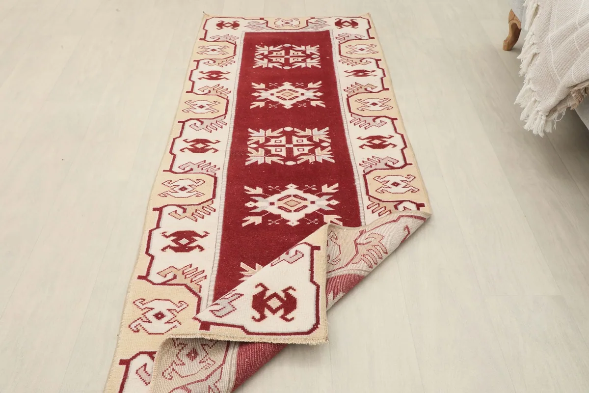 Runner partially folded, revealing the reverse side and the hand-knotting craftsmanship.