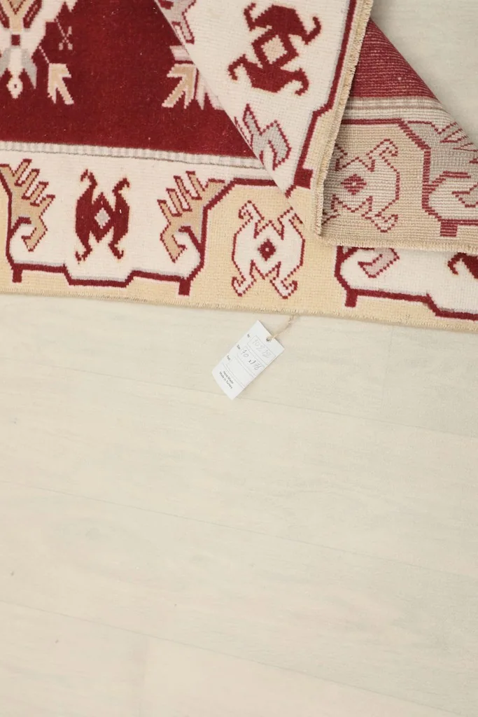 Close-up of the rug's label attached to the back, indicating its origin and material.