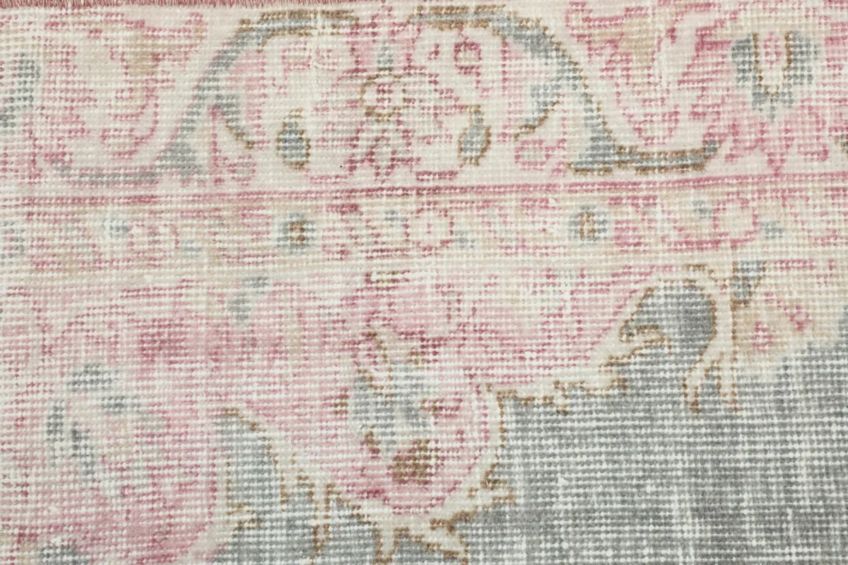 Detailed view of the rug's surface, showing the low pile and intricate hand-knotted texture