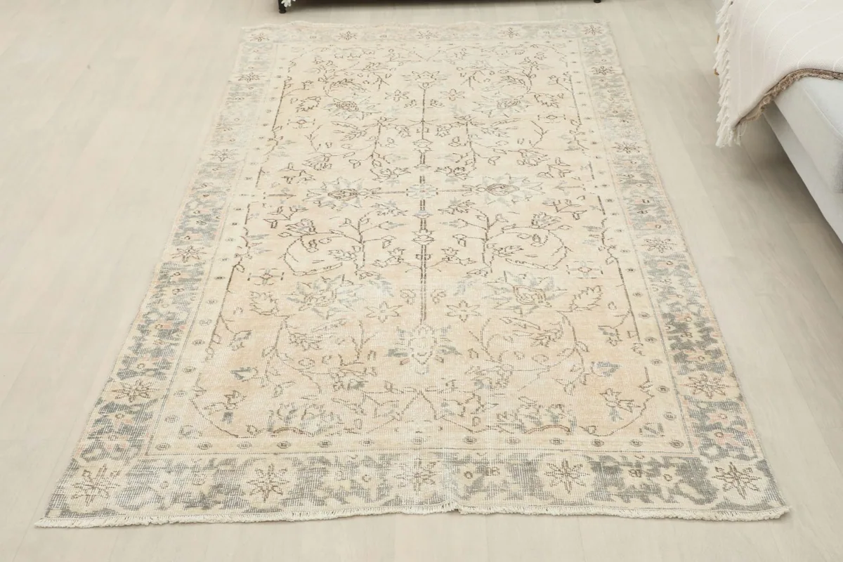 Overhead view of the beige and charcoal rug laid out in a room, offering a full perspective.