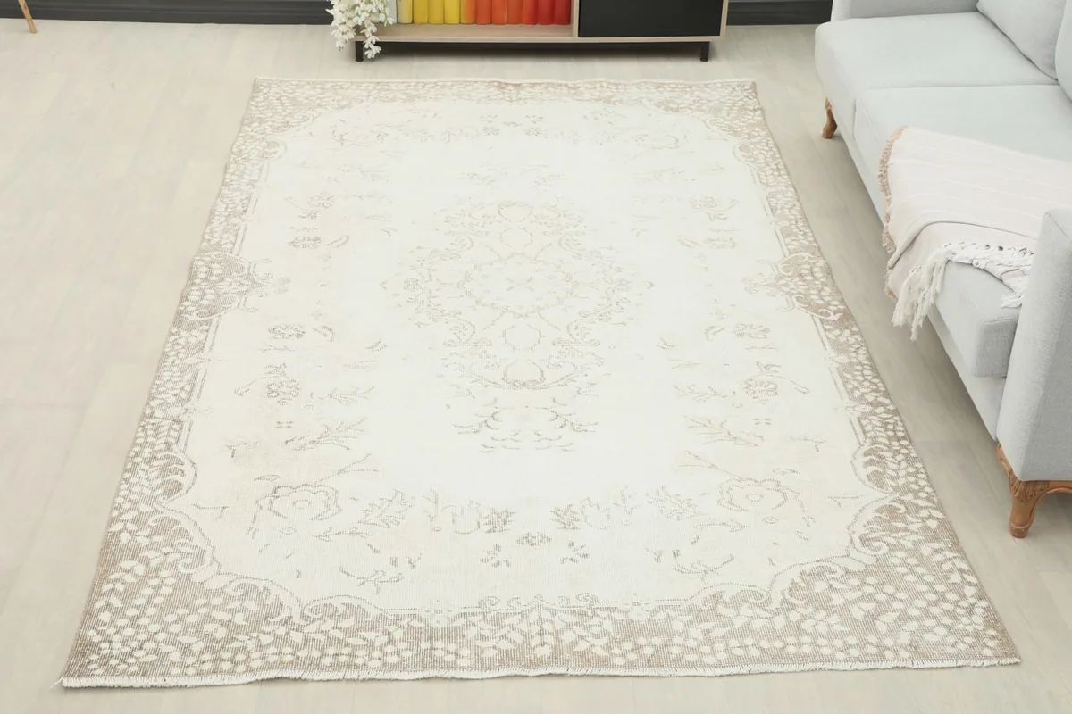 Another room view of the ivory and beige vintage rug, showcasing its full size and how it complements the space.