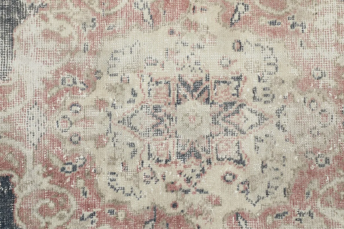 Detailed close-up of the intricate patterns within the central medallion, showing color variation